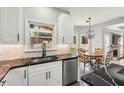 Updated kitchen with dark countertops, stainless steel dishwasher, and a view to the backyard at 10300 Medridge Cir, Johns Creek, GA 30022