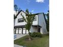 Striking home with two-car garage and manicured lawn, a perfect suburban retreat at 1923 Westfall Lndg, Auburn, GA 30011