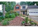 Beautifully landscaped front yard with lush greenery and stone accents at 2212 Mcquiston Sw Dr, Marietta, GA 30064