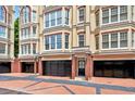 Exterior facade showing private garages, brick columns and detailed architecture of the townhome at 3541 Roswell Ne Rd # 21, Atlanta, GA 30305