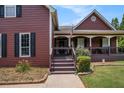 Inviting front porch with cozy seating offers a charming welcome to the home at 1951 Chambers Rd, Mcdonough, GA 30253