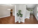 Inviting hallway with wood-look flooring, modern gray walls, and a decorative houseplant at 4546 Water Mill Dr, Buford, GA 30519