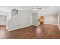 Bright and open living room with hardwood floors, neutral paint, and stairs leading to the upper level at 4546 Water Mill Dr, Buford, GA 30519