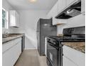 Well-lit kitchen with granite counters, stainless appliances, and ample cabinet space at 5653 Bradley Cir, Lithonia, GA 30038