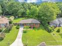 An overhead shot of a brick ranch home with lush landscaping and a covered carport at 701 Green Acres Se Rd, Smyrna, GA 30080