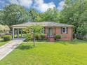 Attractive single-story brick home with an inviting front lawn and a convenient attached carport at 701 Green Acres Se Rd, Smyrna, GA 30080