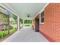 Spacious covered patio featuring brick siding, a ceiling fan, and an outdoor living space at 701 Green Acres Se Rd, Smyrna, GA 30080