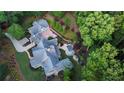 Aerial view of sprawling property with pool, covered patio, and lush landscaping at 114 Trinity Hollow Dr, Canton, GA 30115