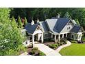Beautiful home with lush landscaping, manicured lawn, and a circular driveway at 114 Trinity Hollow Dr, Canton, GA 30115