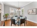 Cozy dining area featuring hardwood floors, gray walls, and glass table with seating for six at 1993 Haley Walk, Atlanta, GA 30318