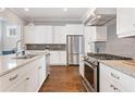 Modern kitchen with stainless steel appliances, white cabinets, granite countertops, and hardwood flooring at 1993 Haley Walk, Atlanta, GA 30318