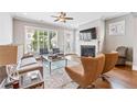 Bright living room with hardwood floors, fireplace, and large windows offering natural light and neighborhood views at 1993 Haley Walk, Atlanta, GA 30318
