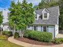 A charming view of the home's side and Dormer windows with lush greenery at 3970 Genoa Ct, Duluth, GA 30096