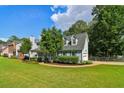 Well-manicured lawn and lush landscaping surround a two-story home with dormer windows at 3970 Genoa Ct, Duluth, GA 30096