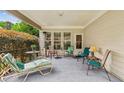 Inviting covered porch with comfortable seating for relaxation and outdoor enjoyment at 5105 Kings Common Way, Cumming, GA 30040