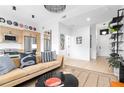 Open-concept living room features a stylish couch and a modern, eat-in kitchen at 567 Ponce De Leon Ne Ave # 321, Atlanta, GA 30308