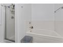 Bathroom featuring tub and shower; neutral wall colors at 11581 Kades Trl, Hampton, GA 30228