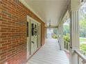 Charming front porch with brick siding, white columns, and decorative details at 3290 Spain Rd, Snellville, GA 30039