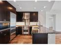 Bright kitchen with stainless steel appliances, wooden floors, and granite countertops at 3325 Piedmont Ne Rd # 2104, Atlanta, GA 30305