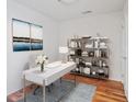 Bright home office with a modern white desk, stylish shelving unit, and a decorative rug at 3325 Piedmont Ne Rd # 2104, Atlanta, GA 30305