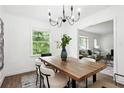 Dining area with wood table, stylish chandelier, and neutral decor at 1606 Van Epps Se St, Atlanta, GA 30316
