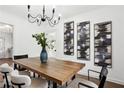 Dining area with wood table, chandelier, and modern wall art at 1606 Van Epps Se St, Atlanta, GA 30316