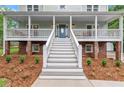 Welcoming front porch with stairs leading to the entrance, accented by lush landscaping and charming details at 2060 Candlewood Ne Ct, Marietta, GA 30066