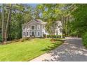 Inviting two-story home with well-maintained lawn and a long driveway lined with lush trees at 5396 Turnbill Nw Pt, Acworth, GA 30101