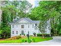 Traditional two-story home with a well-maintained lawn, mature trees, and a charming mailbox at 5396 Turnbill Nw Pt, Acworth, GA 30101