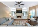 Cozy living room featuring custom built-ins, a fireplace, and lots of comfortable seating at 5396 Turnbill Nw Pt, Acworth, GA 30101