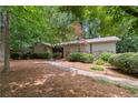 Inviting single-story home with landscaped front yard and charming walkway at 217 Millbrook Farm Rd, Marietta, GA 30068