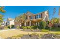 Beautiful two-story home with stone accents, a well-kept lawn, and a welcoming front garden at 2235 Well Springs Dr Dr, Buford, GA 30519