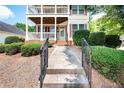 Inviting two-story home featuring double balconies and meticulous landscaping at 65 Orchard Dr, Covington, GA 30014