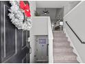 Light-filled entryway with staircase and view into the open concept kitchen at 126 Laguna Springs Dr, Woodstock, GA 30188