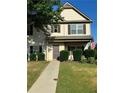 Charming home with a well-kept lawn, decorative shrubbery, and inviting walkway to the front door at 203 Creek View Ln, Acworth, GA 30102