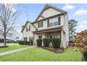 Well-maintained home with lush green lawn and trimmed shrubs, offering a welcoming curb appeal at 203 Creek View Ln, Acworth, GA 30102