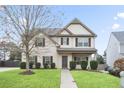Attractive two-story home showcasing a manicured lawn, tidy landscaping, and traditional facade at 203 Creek View Ln, Acworth, GA 30102