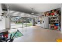 Spacious garage with epoxy flooring, storage shelves, and an automatic door at 11684 Stovall Pl, Hampton, GA 30228