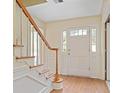 Bright foyer featuring hardwood floors, staircase, and paneled front door at 1338 Nonie Way, Marietta, GA 30062