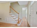 Bright foyer featuring hardwood floors, staircase, and paneled front door at 1338 Nonie Way, Marietta, GA 30062