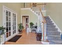 Spacious foyer with hardwood floors, staircase, and entry to other rooms at 155 Matthew Way, Fayetteville, GA 30214