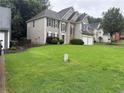 Two-story home with stone accents and a two-car garage sits on a well-maintained lawn at 3015 Cranbrook Nw Walk, Kennesaw, GA 30144