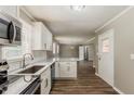 Bright, updated kitchen with stainless steel appliances, white cabinetry and eat-in counter at 4447 Ben Hill Rd, Lithia Springs, GA 30122