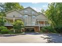 Multi-story condo building with covered parking and lush green surroundings providing convenient and scenic living at 4467 Pineridge Cir, Atlanta, GA 30338