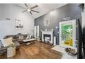 Bright living room with hardwood floors, vaulted ceiling, fireplace, and access to a screened porch at 4467 Pineridge Cir, Atlanta, GA 30338