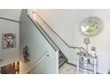 Stylish staircase featuring modern railings, grey trim, and an elegant decorative mirror at 4467 Pineridge Cir, Atlanta, GA 30338