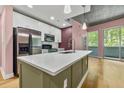 Charming kitchen with a waterfall edge countertop island and stainless steel appliances at 950 Nw W Peachtree Nw St # 410, Atlanta, GA 30309