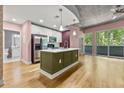 Open kitchen featuring a breakfast bar island, stainless steel appliances, and modern finishes at 950 Nw W Peachtree Nw St # 410, Atlanta, GA 30309