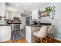 Bright kitchen with white cabinets, modern appliances, and stylish breakfast bar at 1175 Haven Brook Way, Atlanta, GA 30319