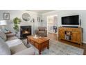 Bright living room with fireplace, TV, hardwood floors, and comfortable seating at 1175 Haven Brook Way, Atlanta, GA 30319